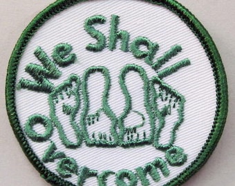 jacket or shirt patch.  WE SHALL OVERCOME.