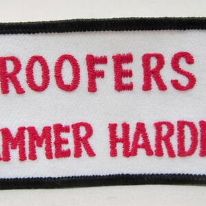 May include: White patch with black border and red embroidered text that reads "Roofers Hammer Harder".