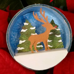 Handmade Christmas Ornament: Reindeer in the forest. Cut paper shadow box