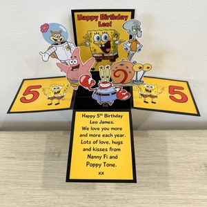 May include: A pop-up birthday card with SpongeBob SquarePants characters. The card is yellow and black, with the number 5 on the sides. The card reads "Happy Birthday Leo!" and includes a personalized message.