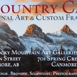 May include: A promotional image for Art Country Canada, featuring a mountain landscape painting. The text includes "Original Art & Custom Framing" and gallery addresses in Canmore, AB. Additional art forms listed include paintings, carvings, bronzes, soapstone, photography, and Inuit art.