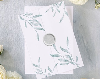 Puede incluir: Un sobre blanco con un diseño de acuarela de hojas verdes y un sello de cera. El sobre está sobre una superficie azul claro con flores blancas y unas tijeras doradas.