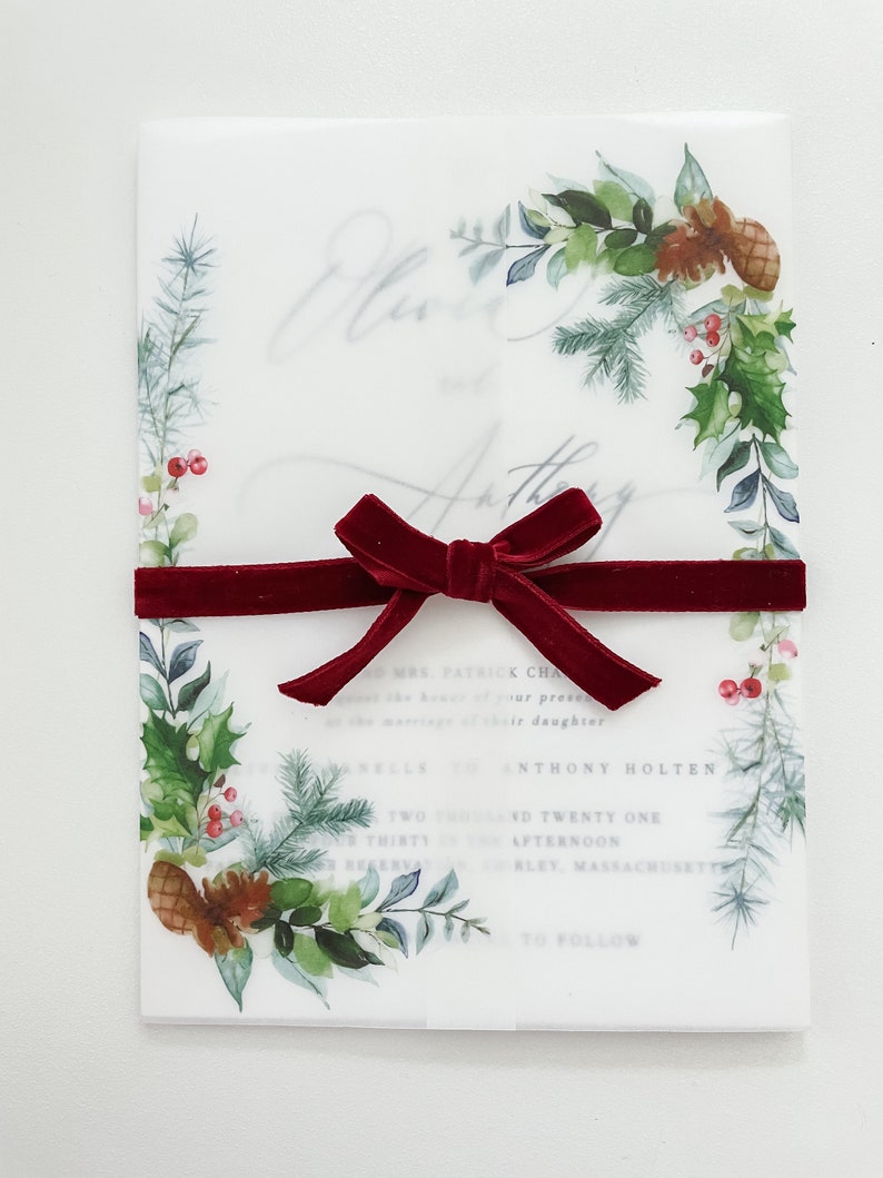 5x7 vellum jacket with evergreen designs on the corners. This clear vellum Christmas Jacket is wrapped around a 5x7 invitation and meets in the middle. Evergreen printed design to dress up your winter wedding invites.