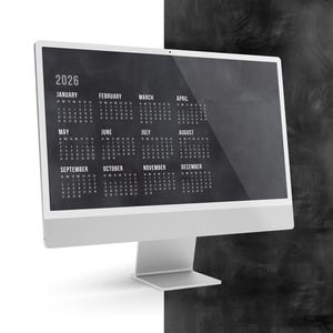May include: A modern computer monitor displays a 2026 calendar against a dark chalkboard-style background. The calendar is in a simple, clean font, with each month's days clearly visible. The monitor has a white frame and a silver stand.
