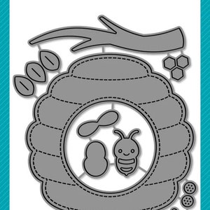 May include: A set of metal craft dies featuring a beehive, bees, honeycomb, flowers, and leaves. The dies are designed to be used with a die-cutting machine. The dies are made in the USA. The text "lawn cuts" and "lawn fawn" are visible in the image.