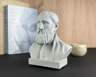 May include: A white bust sculpture of Zeno of Citium, a Greek philosopher, on a black base with the word "ZENO" inscribed on it.