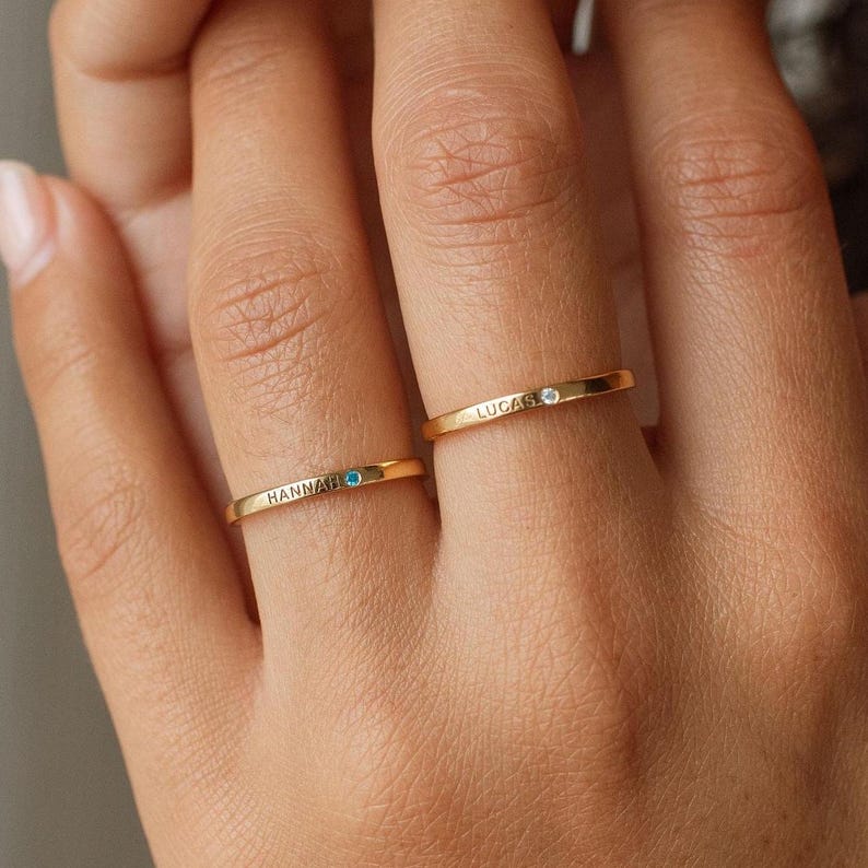 Stackable thin gold rings styled on hand