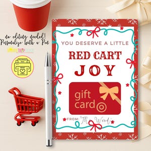 May include: A rectangular gift card holder featuring a red border with white snowflakes and a teal decorative frame. The text reads: YOU DESERVE A LITTLE RED CART JOY. A red gift card graphic with a gold bow is centered, with a FROM line at the bottom.