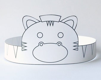 May include: A printable zebra head crown template. The crown is black and white and features a zebra face with stripes and ears. The crown is designed to be cut out and worn as a headband.