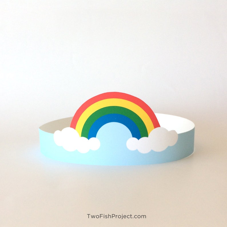 May include: A paper rainbow crown with a blue sky and white clouds. The rainbow is red, orange, yellow, green, blue, indigo, and violet.