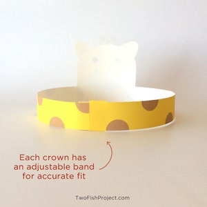 May include: A yellow and brown paper crown with a white cat face cutout. The crown has an adjustable band for a secure fit. "Each crown has an adjustable band for accurate fit" is written below the crown.