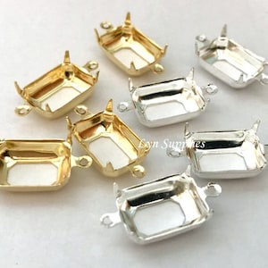 May include: Assortment of gold and silver metal settings for rectangular cabochons. The settings have two loops on each side for attaching to jewellery.