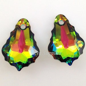 May include: Two iridescent teardrop-shaped crystal pendants with a hole at the top for hanging. The crystals are a mix of green, blue, yellow, and red.