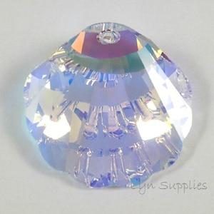 May include: A clear iridescent crystal bead in the shape of a seashell with a hole in the top for stringing.