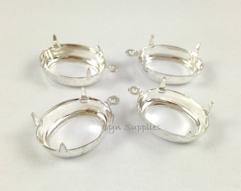 May include: Four silver oval-shaped pendant settings with prongs. The settings are designed to hold a cabochon stone.