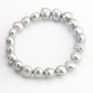 May include: A bracelet made of a strand of gray pearls.