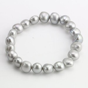 May include: A silver pearl bracelet with a strand of round, irregular pearls.