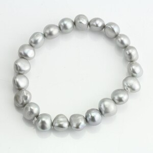May include: A silver pearl bracelet with a strand of round, irregular pearls.