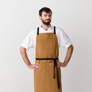 Cross back apron for men with pockets | Ochre canvas with Black Straps | Chefs, bakers, BBQ, shop, kitchen | Restaurant, Work, Professional