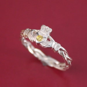 Claddagh ring. Fancy yellow diamond Claddagh ring on celtic rope band.