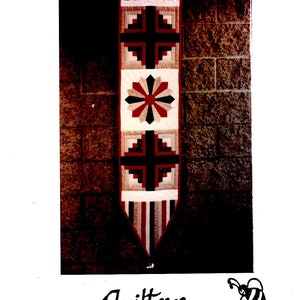 May include: A quilting pattern for a "Royal Door Hanging & Table Runner" featuring a red, white, and blue design with a cross, a flower, and stripes. The pattern is from "Quilters Haven" located at 8998 Foothill Blvd., Rancho Cucamonga, CA 91730, 714/989-6467.