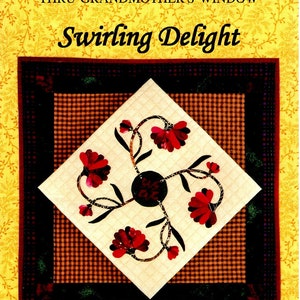 May include: A quilt pattern titled "Swirling Delight" from the "Thru Grandmother's Window" series. The pattern features a white background with four red flowers and black stems. The quilt is framed with a brown and black plaid border.