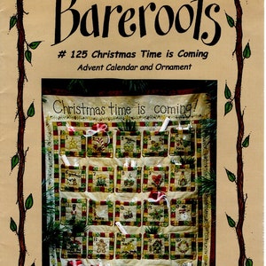 May include: A cross-stitch pattern for a Christmas advent calendar and ornament. The pattern features a red, green, and white color scheme with a variety of Christmas-themed images, including a snowman, a gingerbread man, and a reindeer. The text "Christmas time is coming!" is stitched in the top center of the pattern.