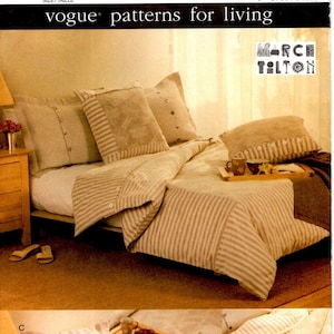May include: A sewing pattern for a bedspread and pillowcases. The pattern is for a striped bedspread with a floral design. The pattern is from Vogue Patterns for Living and is number 7562.