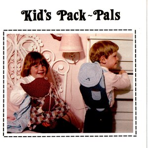 May include: A vintage craft pattern for making two plush toys, "Sunbonnet Sue" and "Overall Sam". The pattern includes full-size pieces and instructions for making the toys. The image shows two children holding the finished toys.