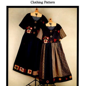 May include: A sewing pattern for a folk art dress with two different designs. The pattern includes appliques and is for a child's dress. The pattern is called "Folk Art Dress" and is number 348.