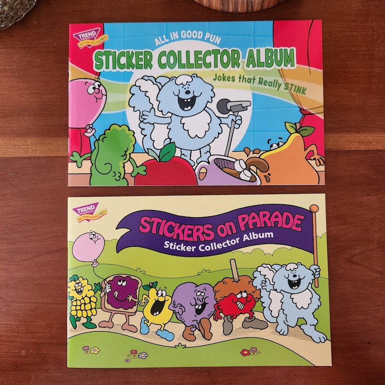 May include: Two vintage sticker collector albums. The top album is blue and red with the text "ALL IN GOOD PUN STICKER COLLECTOR ALBUM Jokes that Really STINK". The bottom album is green with the text "STICKERS on PARADE Sticker Collector Album".