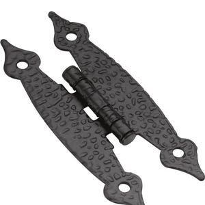 May include: A black metal strap hinge featuring a textured, hammered surface finish. The hinge consists of two elongated, pointed plates connected by a central cylindrical barrel, with four circular screw holes visible on the decorative ends.