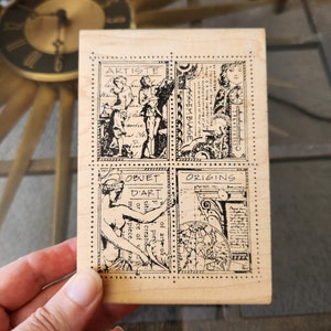 May include: A rectangular wooden stamp with four black and white illustrations. The top left illustration features two figures with the word "ARTISTE". The top right illustration has the word "ASSEMBLAGE". The bottom left illustration has the words "OBJET D'ART". The bottom right illustration has the word "ORIGINS".
