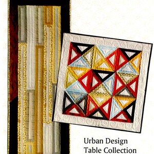 May include: Two quilted table runners, one with a geometric pattern of black, red, white, and yellow triangles, and the other with a geometric pattern of black, white, and gold stripes. The text "Urban Design Table Collection" is printed below the runners.