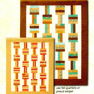 May include: Two quilt patterns with a geometric design of stacked squares in shades of brown, orange, yellow, and teal. The smaller quilt is framed in tan and the larger quilt is framed in brown. The text "use fat quarters or precut strips" is at the bottom of the image.