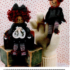 May include: Thimble Theater Puppet Dolls pattern, featuring a girl and boy puppet with red hair, black and white striped pants, and button shoes. The pattern is titled "Thimble Annie & Andy" and includes instructions for making a 5 inch puppet doll with button shoes and hands. The pattern is from Keeping You In Stitches and is labeled KS-148.