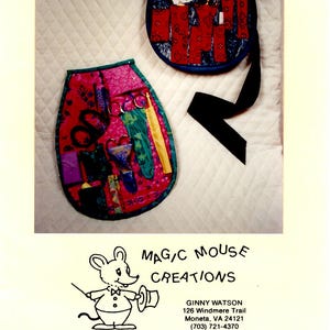 May include: Two fabric pockets with different patterns and designs. The pocket on the left is pink with green, yellow, and purple accents. The pocket on the right is blue with red, white, and black accents. The text "The Ultimate Pocket" is at the top of the image. The text "MAGIC MOUSE CREATIONS" is at the bottom of the image, along with the business owner's name, address, and phone number.