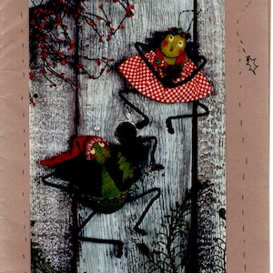 May include: A pattern for making two Christmas-themed felt ornaments, an angel and a Santa, shaped like crickets. The pattern is called "Christmas Crickets" and is numbered #RR69. The ornaments are approximately 8 inches tall.