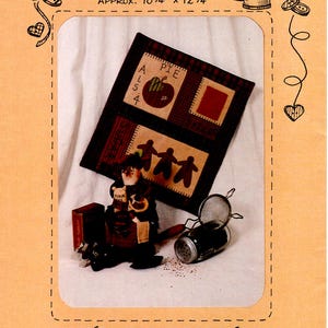 May include: A quilt pattern called "Spicy Lady" by Hanging by a Thread. The pattern features a red and white checkered background with a red apple, a red square, and three brown figures holding hands. The quilt is approximately 10 3/4 inches by 12 1/4 inches.