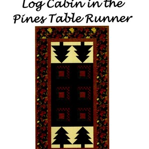 May include: A table runner with a log cabin design featuring black, white, and red squares. The center of the runner has a design of two pine trees with a cream background. The runner has a border of red, green, and brown leaves.