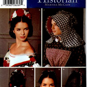 May include: A vintage sewing pattern for a historical costume. The pattern includes instructions for making a bonnet, a dress, and a hairstyle. The pattern is from Simplicity and is titled "The Fashion Historian" by Martha McCain.