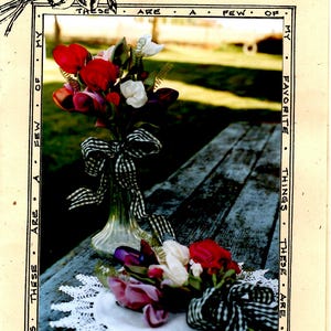May include: A bouquet of sweet pea posies in a clear glass vase with a black and white checkered ribbon. The vase is sitting on a wooden table with a white lace doily. The text "THESE ARE A FEW OF MY FAVORITE THINGS THESE ARE A FEW OF MY FAVORITE THINGS" is written around the border of the image.