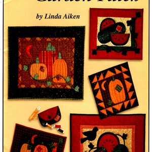 May include: A set of five quilt patterns featuring a variety of garden themes, including pumpkins, watermelons, and a bird. The patterns are titled "In The Garden Patch" and are by Linda Aiken.