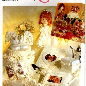 May include: A Simplicity Crafts pattern for making wedding-themed crafts, including a doll, a cake, a heart-shaped box, and a photo album. The pattern number is 7086.
