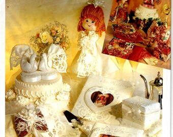 May include: A Simplicity Crafts pattern for making wedding-themed crafts, including a doll, a cake, a heart-shaped box, and a photo album. The pattern number is 7086.