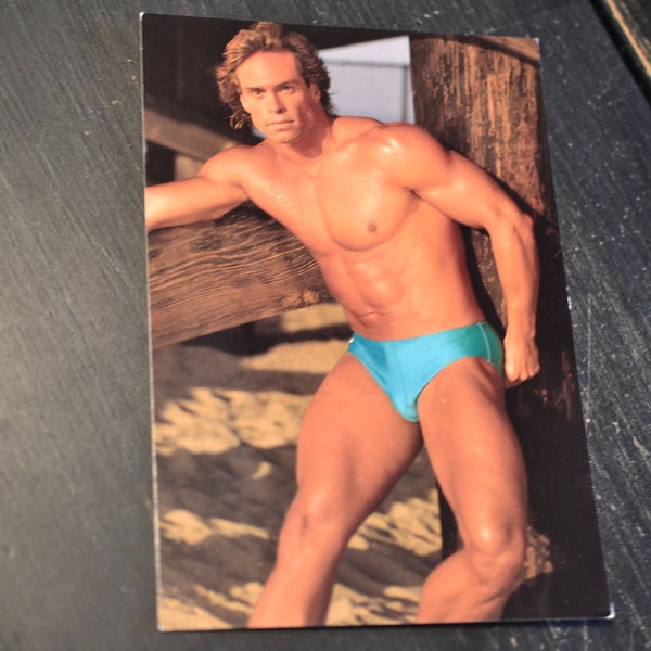 80s Beefcake Postcard Gay Interest Hot Bodz Male Model Photo Blonde Man Turquoise Banana Hammock Under Pier Beach Scene Outdoors Athletic