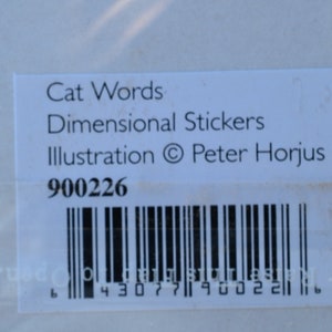 May include: White label with black text that reads "Cat Words Dimensional Stickers Illustration &copy; Peter Horjus" and the number "900226". A black and white barcode is below the text.