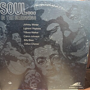 May include: Vintage vinyl record album cover for "SOUL... IN THE BEGINNING." The cover is predominantly black with faded images of musicians and the album title in white. Featured artists include Johnny Winter, Lightnin' Hopkins, and T-Bone Walker.