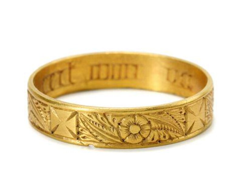 Pu&ograve; includere: Un anello a fascia d'oro con intricati disegni floreali e a croce. L'iscrizione "mit dir" &egrave; incisa all'interno della fascia.