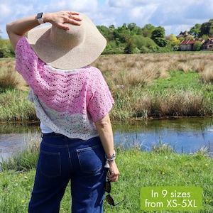 May include: A woman wearing a pink and white crochet cardigan with a wide-brimmed straw hat and blue jeans. The cardigan is crocheted in a delicate pattern and has a relaxed fit. The text "MELLOW WAVES: CROCHET CARDIGAN PATTERN" is at the bottom of the image. The text "In 9 sizes from XS-5XL" is in a pink box in the lower right corner of the image.